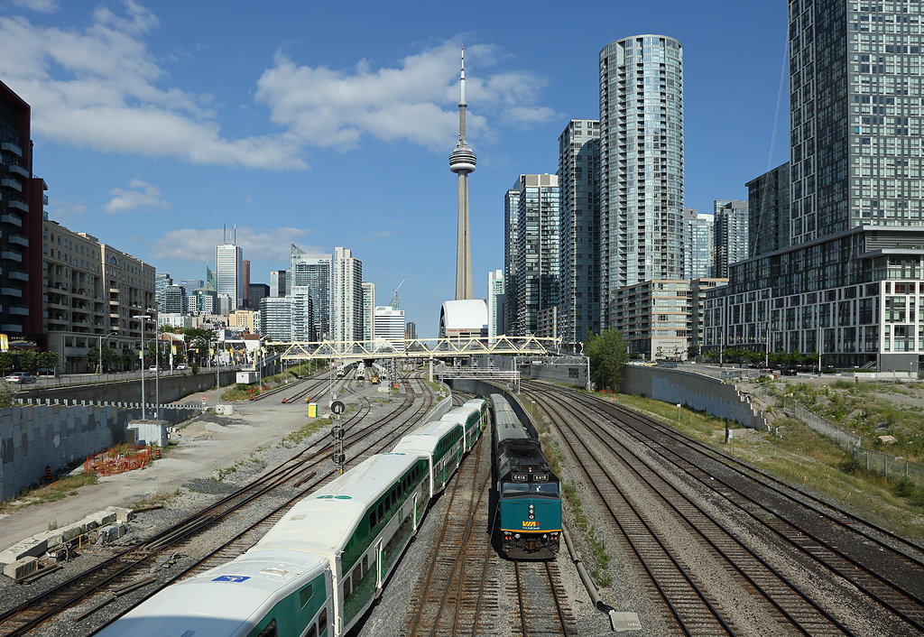 6418 departs Toronto with train 83, 1635 Toronto Union-London, 6 Aug 2015.

The CN Tower is in the background.