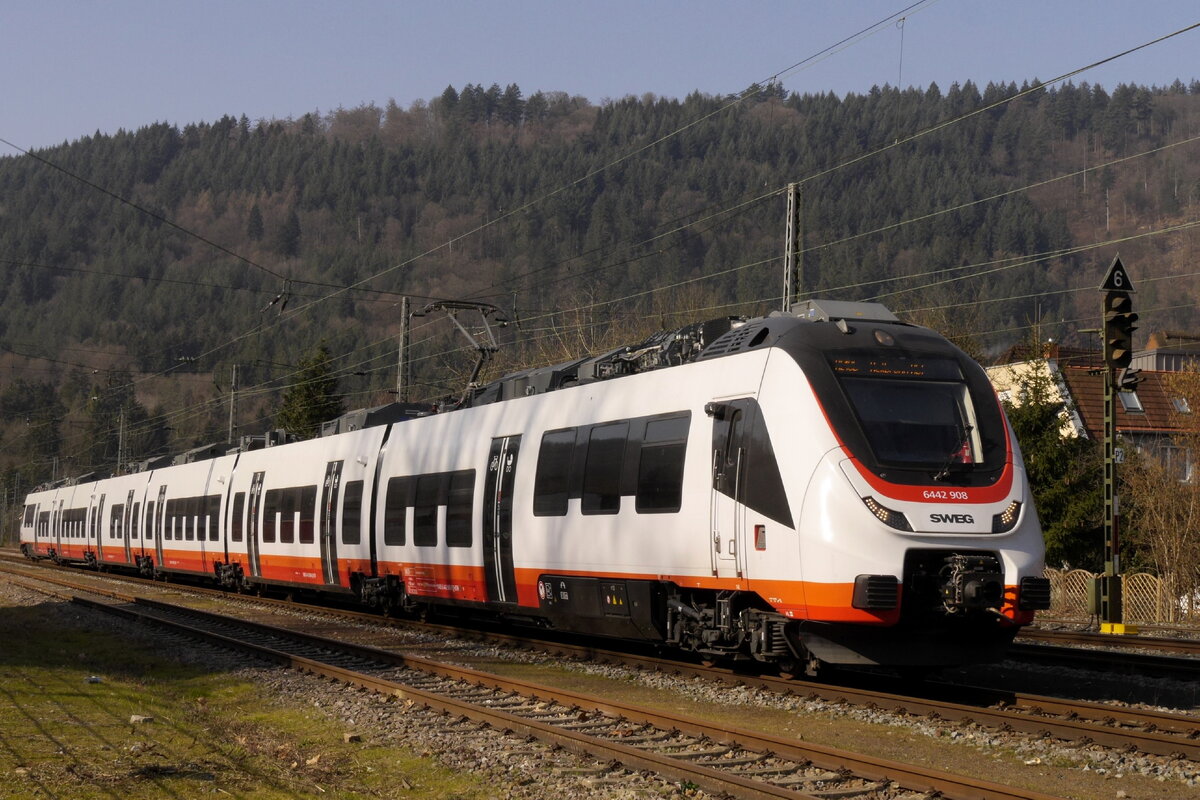 6442 408 fährt als RE 10b nach Heilbronn in Neckargemünd ein. Das Halterkürzel lautet D-BTH (Bombardier Transport Holding), einsetzendes EVU ist die SWEG. Das Foto vom 2.3.23 wurde vom Parkplatz hinter dem Bahnsteig an Gleis 4 aufgenommen.