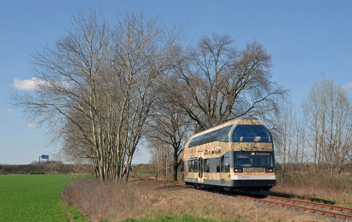 670 003 erreicht auf dem Weg von Dessau nach Oranienbaum soeben den Haltepunkt Dessau-Adria. 