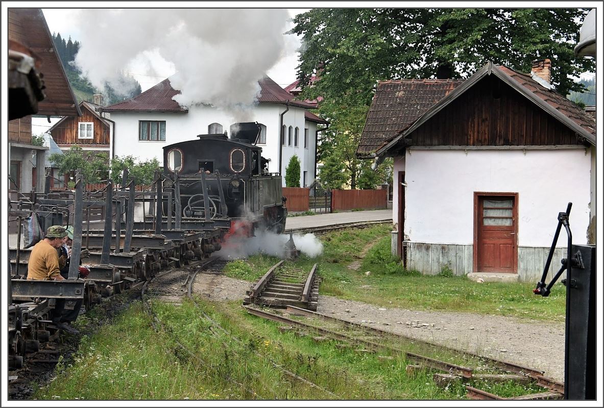 764.404R rumpelt mit ihren leeren Holzdrehschemelwagen aus dem Bahnhofgelände von Moldovita. (14.06.2017)
