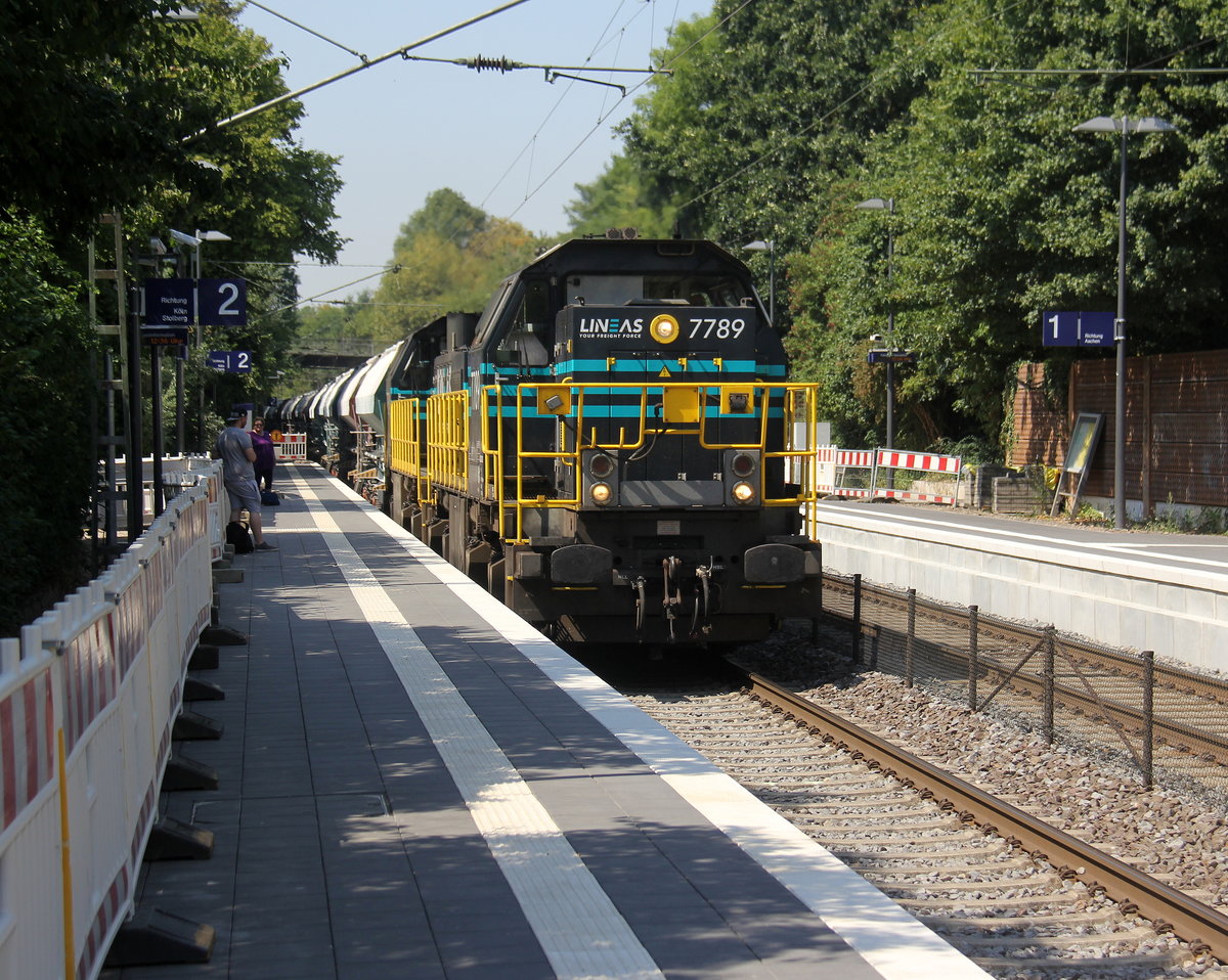 7789,7784 beide von Lineas kommen als Umleiter mit einem schweren Kalkzug aus Hermalle-Huy(B) nach Oberhausen-West(D) und kommen aus Richtung Montzen(B), Welkenraedt(B),Lontzen(B),Astenet(B),Hergenrath(B),Aachen-Süd(D),Aachen-Hbf,Aachen-Rothe-Erde und fahren durch Aachen-Eilendorf in Richtung Stolberg-Hbf(Rheinland)Eschweiler-Hbf,Langerwehe,Düren,Merzenich,Buir,Horrem,Kerpen-Köln-Ehrenfeld,Köln-Nippes,Köln-Longerich,Köln-Chorweiler,Köln-Worringen,Dormagen-Bayerwerk,Dormagen,Nievenheim,Neuss-Allerheiligen,Norf,Neuss-Süd,Neuss-Hbf,Neuss-Gbf,Meerbusch-Osterath,Krefeld-Oppum,Krefeld-Linn,Krefeld-Uerdingen,Krefeld-Hohenbudberg-Chempark,Duisburg-Rheinhausen,Duisburg-Rheinhausen-Ost,Duisburg-Hochfeld-Süd.
Aufgenommen vom Bahnsteig 2 in Aachen-Eilendorf. 
Bei Sommerwetter am Mittag vom 2.8.2018.