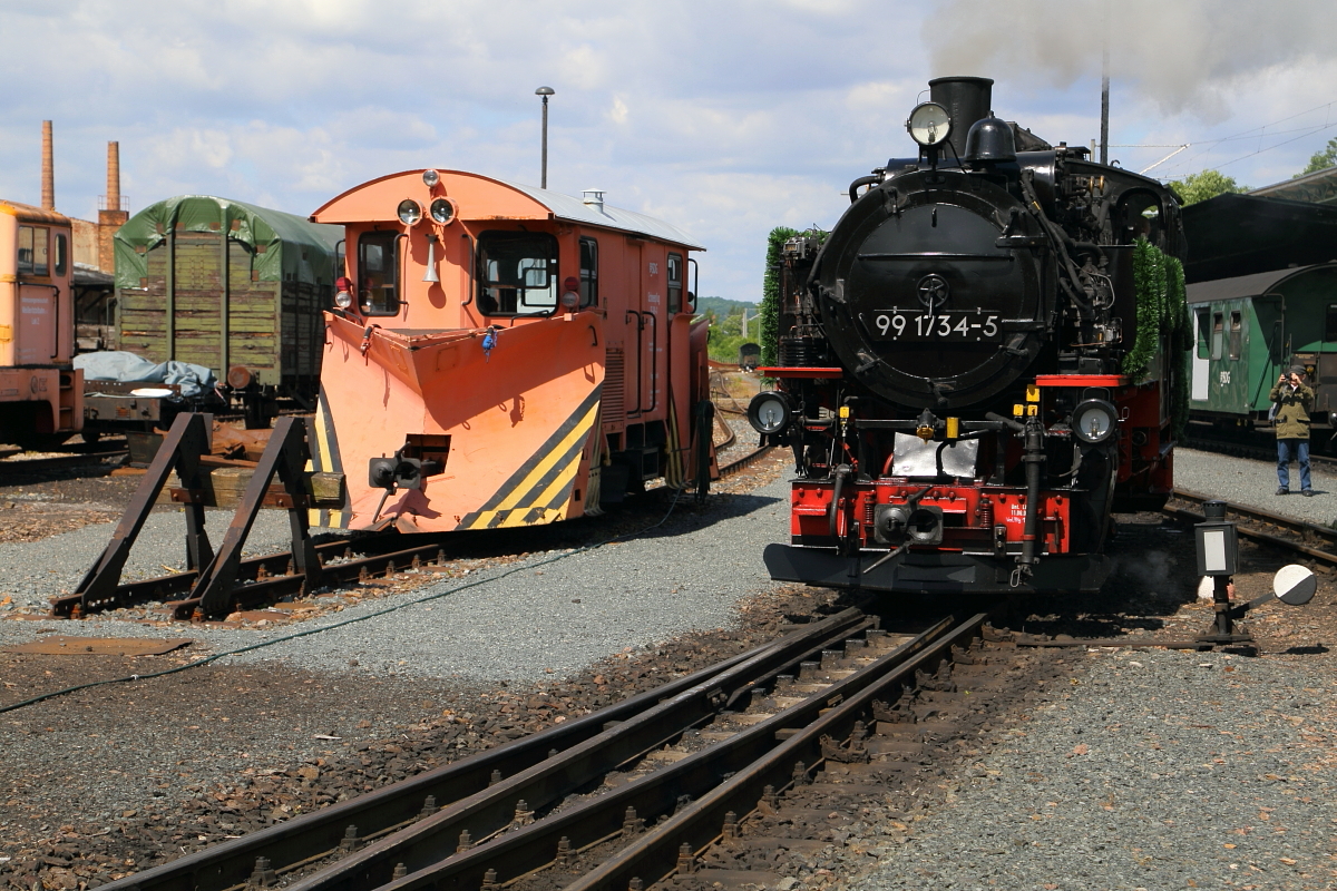 99 1734 am 17.06.2017 auf Rangierfahrt im Bw Freital-Hainsberg. Sie hat gerade ihren Kohlevorrat aufgefrischt und wird sich, nachdem sie Wasser genommen hat, gleich wieder mit 99 1793 vereinigen, um den, nun schon zweiten, öffentlichen Planzug, nach der Wiederinbetriebnahme des Streckenabschnittes Dippoldiswalde - Kurort Kipsdorf, hinauf zum letztgenannten Bahnhof zu bringen. Die Aufnahme entstand im Rahmen der zweitägigen Eröffnungsfeier. (Bild 2) Der links stehende Schneepflug hatte an jenem Tag, aus wohl sichtbaren Gründen, für einen Einsatz keinerlei Chance! ;-)