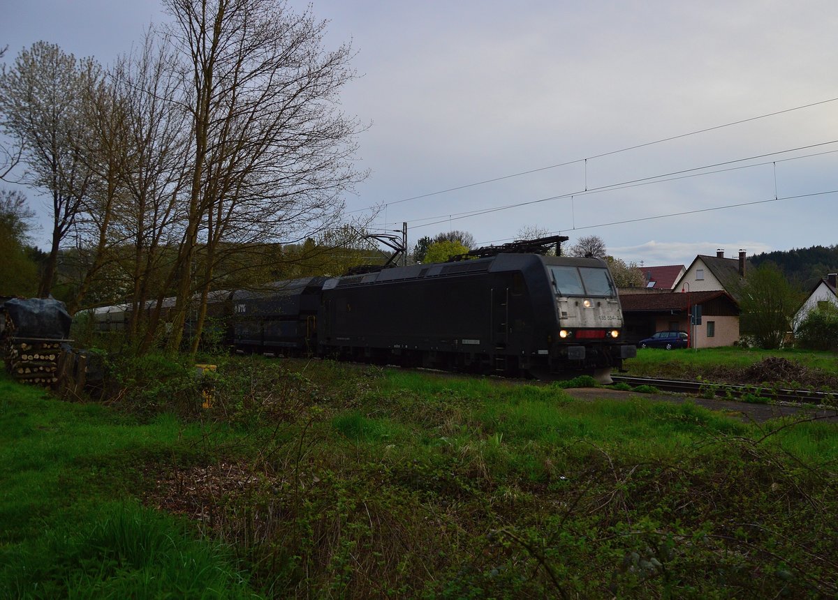 Abendbild aus Neckargerach.
Die 185 554-3 kommt mal wieder mit einem Leerwagenzug die Neckartalbahn gen 
Heidelberg herunter gefahren. Manchmal hat gassigehen mit Benji auch was gutes. 15.4.2016