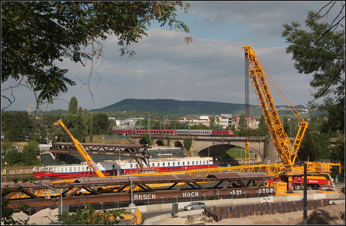 Allerlei am Neckar in Bad Cannstatt -

Während oben eine S-Bahn und ein IC-Zug in Parallelfahrt die Neckarbrücke queren, passiert auf dem Neckar ein Fluss-Kreuzfahrtschiff einen riesigen Kran, dessen Aufgabe es war ein Hälfte des Fußgängersteges wegzuheben um Platz für die neue Eisenbahnbrücke im Rahmen des Projektes Stuttgart 21 zu schaffen.

16.07.2016 (M)

(Hätte ich meine Speicherkarte nicht vergessen und wir deshalb zwischen durch in die Stadt fuhren um dort einen Ersatz zu kaufen, wären wir wohl nicht zu diesem Moment an dieser Stelle gewesen und das Foto mit diesem Schiff und den beiden Zügen wäre so wohl nicht entstanden).

