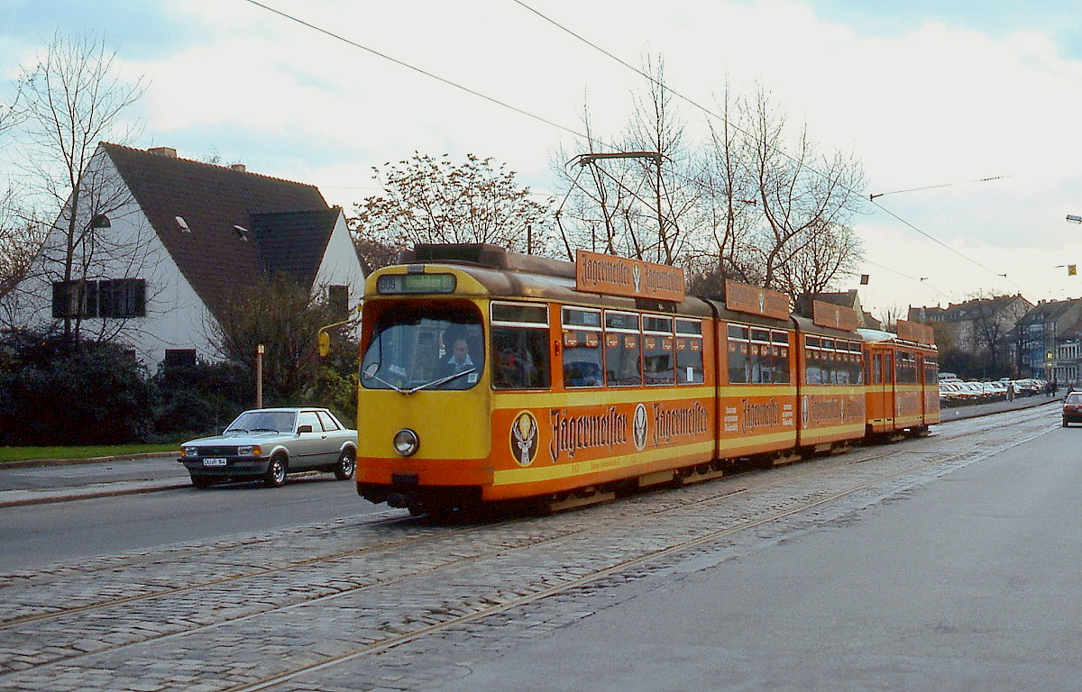 Als kompletter  Jägermeister -Zug fährt ein DVG-Achtachser mit einem der drei Zweirichtungs-Beiwagen Anfang der 1980er Jahre auf der Düsseldorfer Straße in Richtung Innenstadt