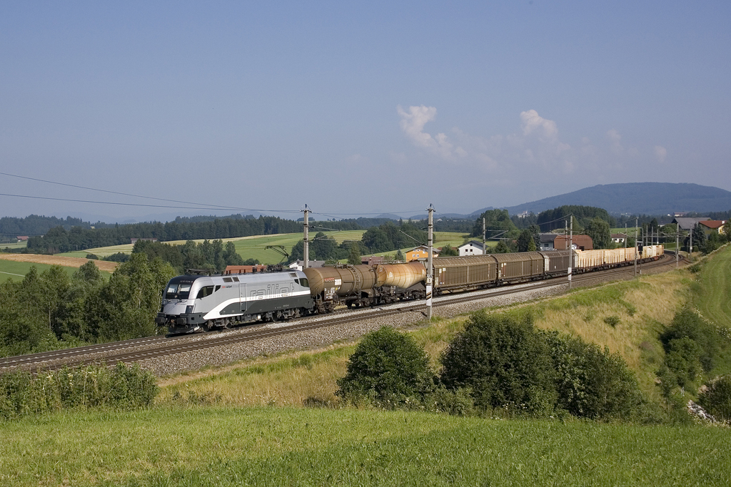 Am 16. Juli 2010 ist die 1016 034 in railjet-Testlackierung mit einem Güterzug unterwegs, hier zu sehen bei Pöndorf.