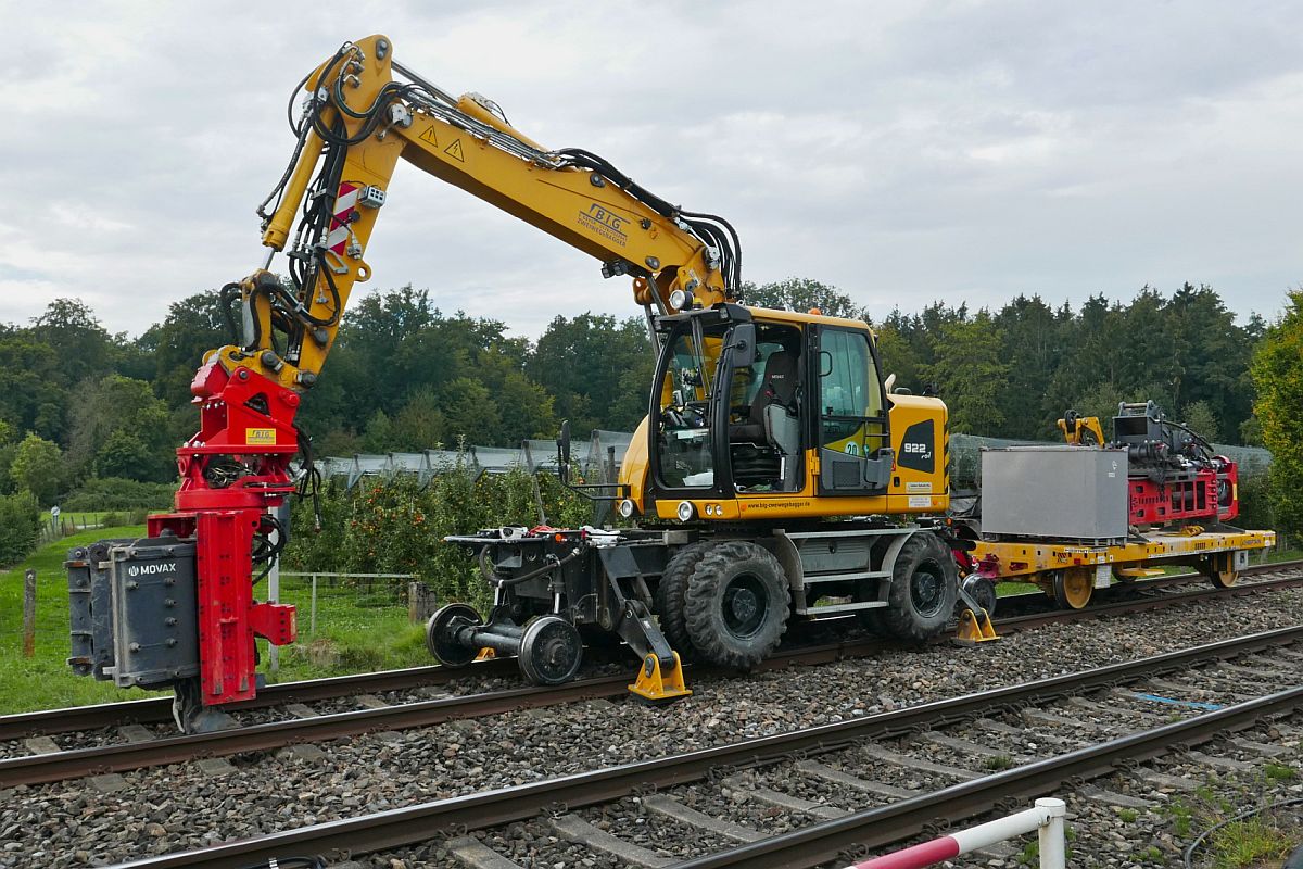 Am 22.09.2020 ist in Meckenbeuren-Brugg ein Zweiwegebagger A 922 Rail abgestellt, an dem eine Vorrichtung zum Aufstellen von Oberleitungsmasten montiert ist. Auf dem Anhnger wird eine Vorrichtung zur Herstellung von Grndungen fr Oberleitungsmasten mitgefhrt.