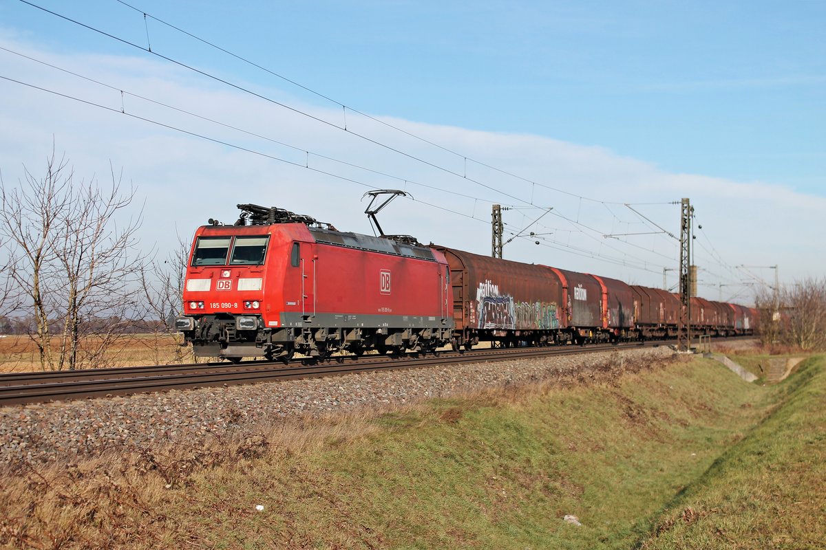 Am 22.12.2016 fuhr 185 090-8  Bombadier Werk Kassel  mit einem gemischten Güterzug (Mannheim Rbf - Chiasso) bei Hügelheim in Richtung Schweizer Grenze. Leider war die Werbung an diesem Tag auf der abgewanten Seite.
