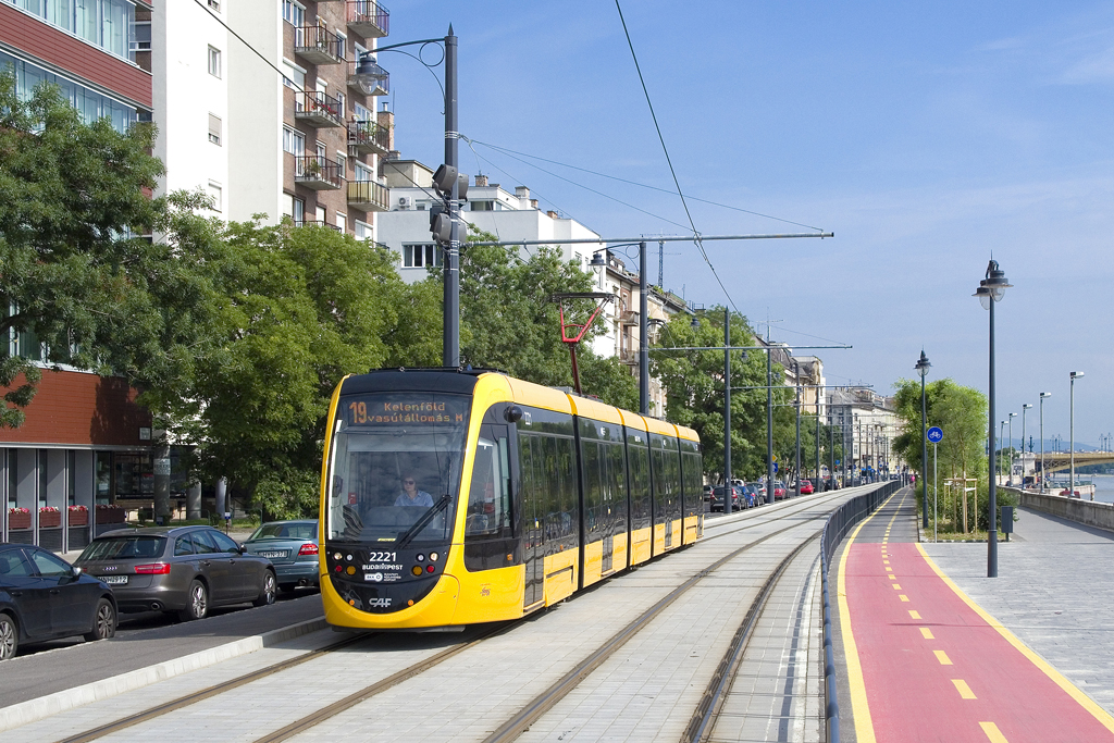 Am 5. Juni 2016 ist TW 2221 am Budaer Donauufer als Linie 19 bei Bem József tér in Richtung Kelenföld vasútállomás unterwegs.