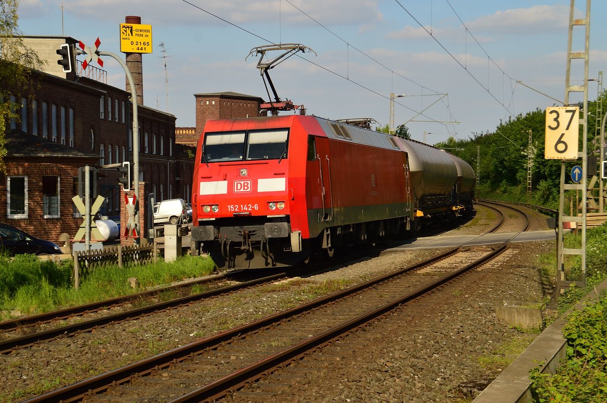 Am Bü Kölner Straße in Jüchen fährt die 152 142-6 samt einem Braunkohlezug aus Niederaussem, den sie in Rommerskirchen übernommen hat. 9.5.2017