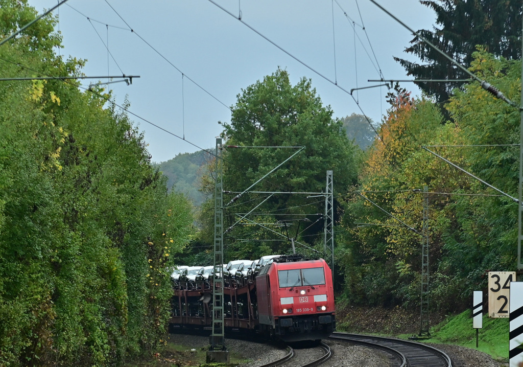 Am Mittag des 24.10.2022 ist die 185 339-9 damit beschäfftigt einen Autotransportzug vom Audiwerk in Neckarsulm gen Heidelberg und weiter nach Seelze zutransportieren, hier ist der Zug in Neckargerach zusehen. 