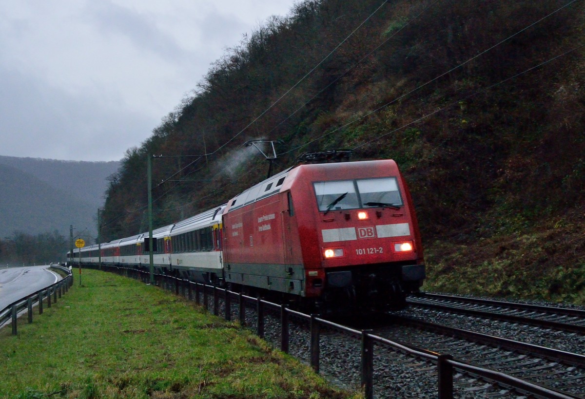 Am Samstagabend zieht die 101 121-2 einen EC aus schweizer Wagons durch das Mittelrheintal in Richtung Koblenz auf der linken Rheinseite. Das es junge Hunde und Katzen regnet lässt sich unschwer an der Wasserfahne am Pantografen erahnen.
4.1.2013