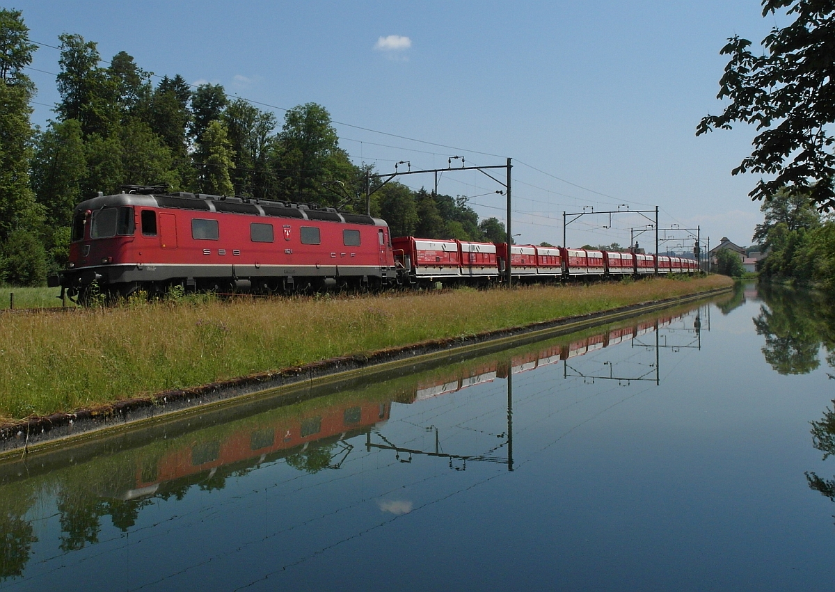 Am Thurkanal bei Brglen (TG) fhrt Re 6/6 11624 'ROTHRIST' mit einem Schttgutwagen-Ganzzug in Richtung Frauenfeld am 19.06.2014 am Fotograf vorbei.