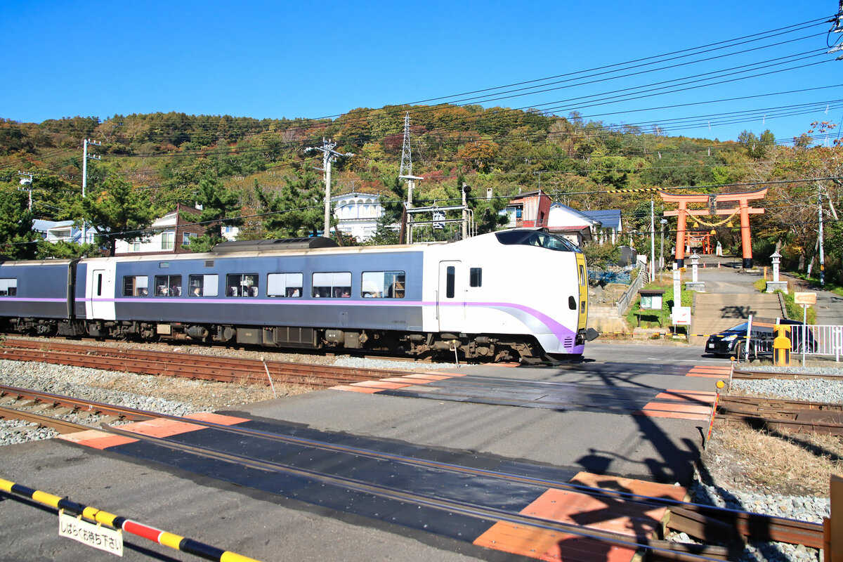 An der Hauptlinie, die die vorübergehende Endstation des Shinkansen in Hakodate und die Hauptstadt von Hokkaidô, Sapporo, verbindet: Einfahrt in Tôya, vor dem dortigen Abuta Jinja (Abuta Götterschrein). Dieseltriebzug, geführt von KIHA 261-1214. 26.Oktober 2022 