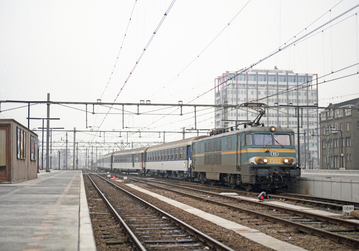 Ankunft des IC-281 (Paris Nord - Amsterdam CS) mit Wagen der SNCF und Lok NMBS nr 1502 am 07.12.1986 in Amsterdam CS. Scan (Bild 94427, Kodak Vericolor III).