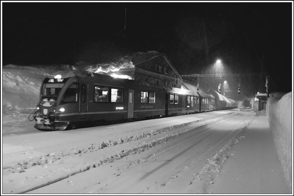 Auch der letzte Zug des Tages zieht leere Holzwagen über den Berninapass und hält nur kurz in Ospizio Bernina. (21.02.2014)
