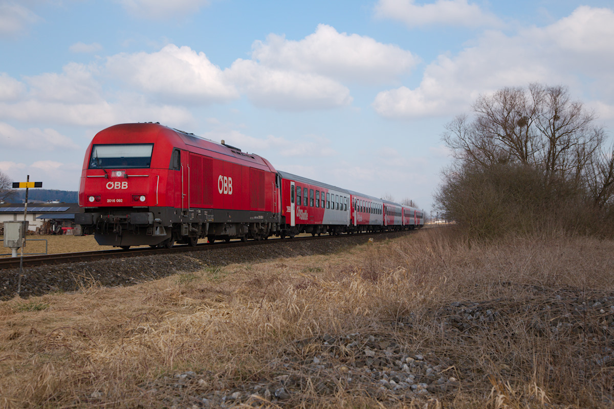 Auf der äußeren Aspangbahn dominieren die Treibwagen der Reihe 5022. Am Samstag des 7.03.2015 jedoch der REX 2707 mit der 2016 092 und einer Wendezug Garnitur, gebildet aus fünf langen Schlieren nach Fehring unterwegs. Entstanden ist diese Aufnahme in Bierbaum, exakt an jener Stelle, wo einst die Strecke nach Neudau abgezeigt ist.