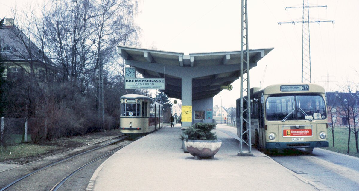 AVG Straßenbahn Augsburg__Tw 511 [GT5, MAN 1956] auf Linie 4 in der Endschleife Haunstetten. Inzwischen hat sich ein Bus der Linie 34 dazu gesellt [wohl ein MAN 750 HO-SL; später = SL192). __09-03-1974