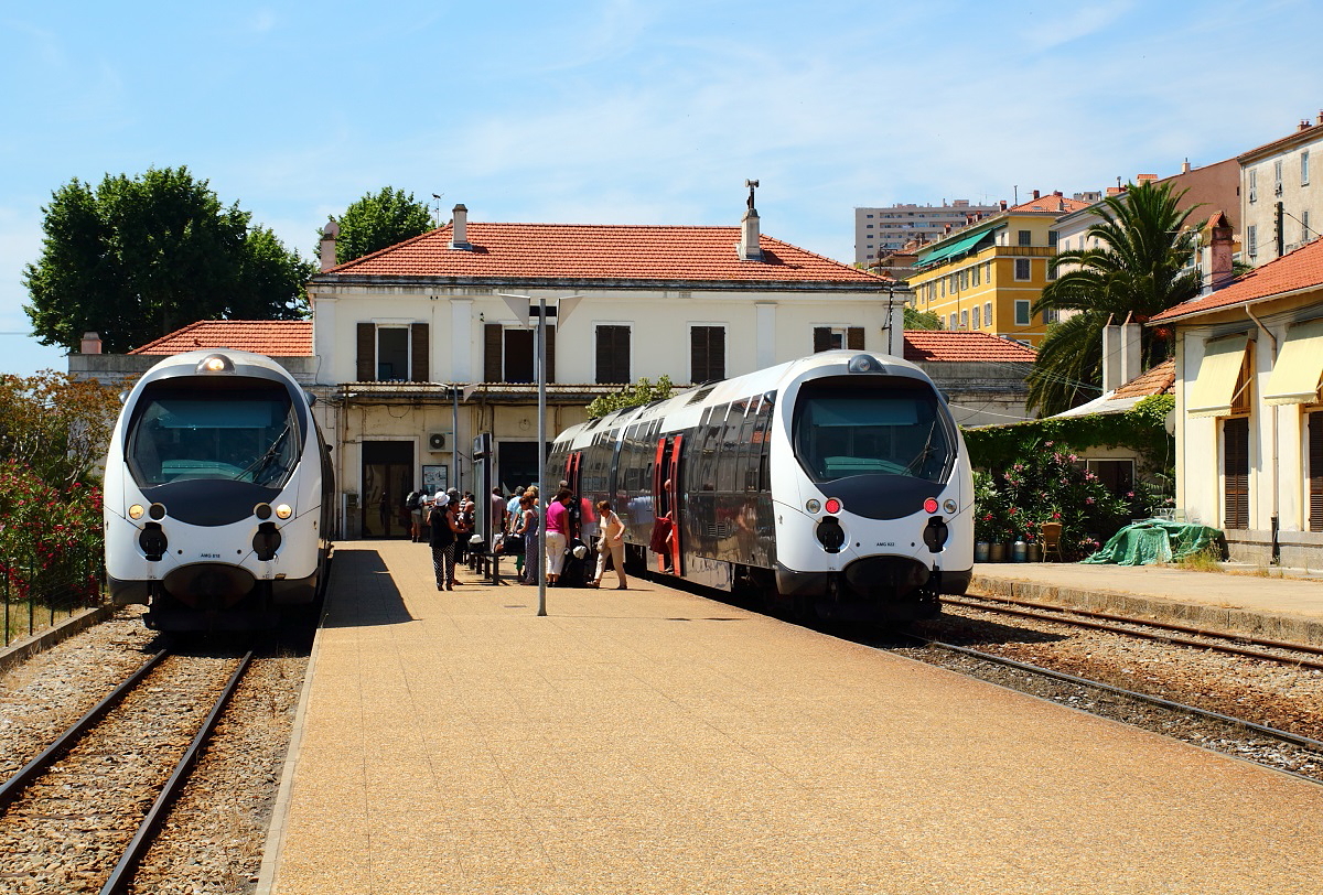 Bahnhof Ajaccio der CFC am 12.06.2014: Während rechts die Fahrgäste den gerade angekommenen AMG 821/822 verlassen, wartet links ein Zug mit AMG 818 an der Spitze auf Passagiere in Richtung Mezzana