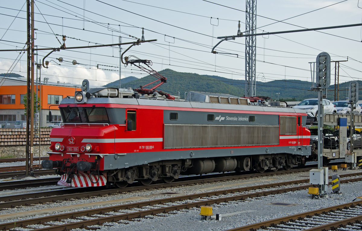 Bahnhof Hrpelje-Kozina in Kozina (Slowenien). Einfahrender Güterzug mit Neuwagen. Als Zuglok dient eine SZ (Slovenske železnice / Slowenische Eisenbahn) Lok der Baureihe 363 (91 79 363 009 – 6). Es ist eine C’ C’ angetriebene Lok (Lok mit einem Antriebsmotor pro Drehgestell. Die Antriebskraft wird jeweils über ein Getriebe und Kardanwellen auf die drei Achsen verteilt). Diese Lok ist verwandt mit der französischen C’C’ 6500. Das Stromsystem ist 3'000 Volt Gleichstrom.