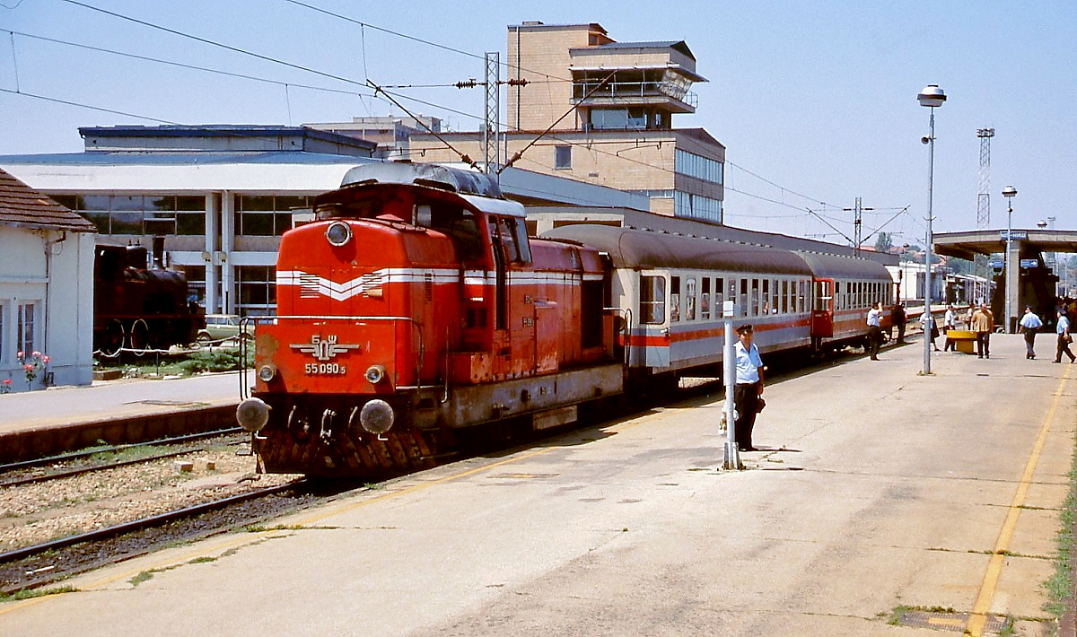 BDZ 55 090.5 im Juni 2000 mit einem grenzüberschreitenden Personenzug nach Bulgarien im damals noch jugoslawischen (heute serbischen) Bahnhof Nis. Man hat den Eindruck, dass sich mehr Bahnpersonal als Reisende auf dem Bahnsteig aufhalten.