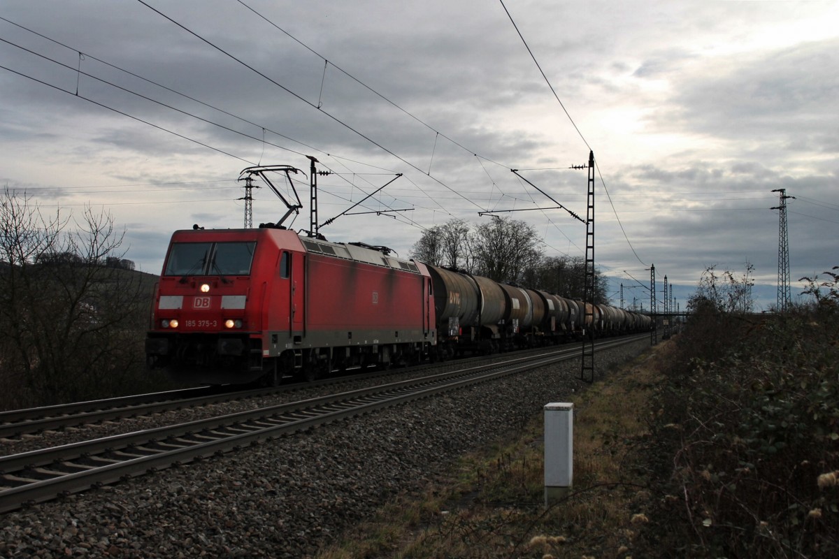 Bei dicken grauen Wolken, fuhr die 185 375-3 mit Fernlicht und einem Kesselwagenzug am Valentinstag 2014 südlich von Müllheim (Baden) gen Norden. Gruß an den sehr netten Tf zurück !!!!
