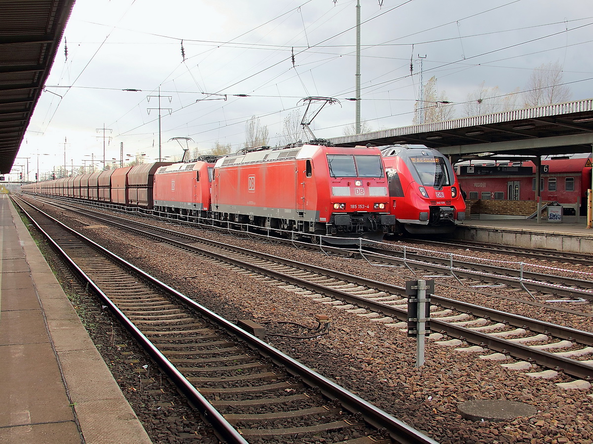 Berlin Schnefeld Flughafen am 30. Oktober 2013, auf Gleis 4 steht 442 328 / 828 als RB 14 in Richtung Senftenberg, im Hintergrund auf Gleis 6 steht ein RE 7 nach Nauen mal wieder mit einer BR 143.
Im Durchfahrtgleis fhrt 185 153-4 mit 185 147-8 mit einem Ganzzug Kohlezug zum Personalwechsel ein. 

