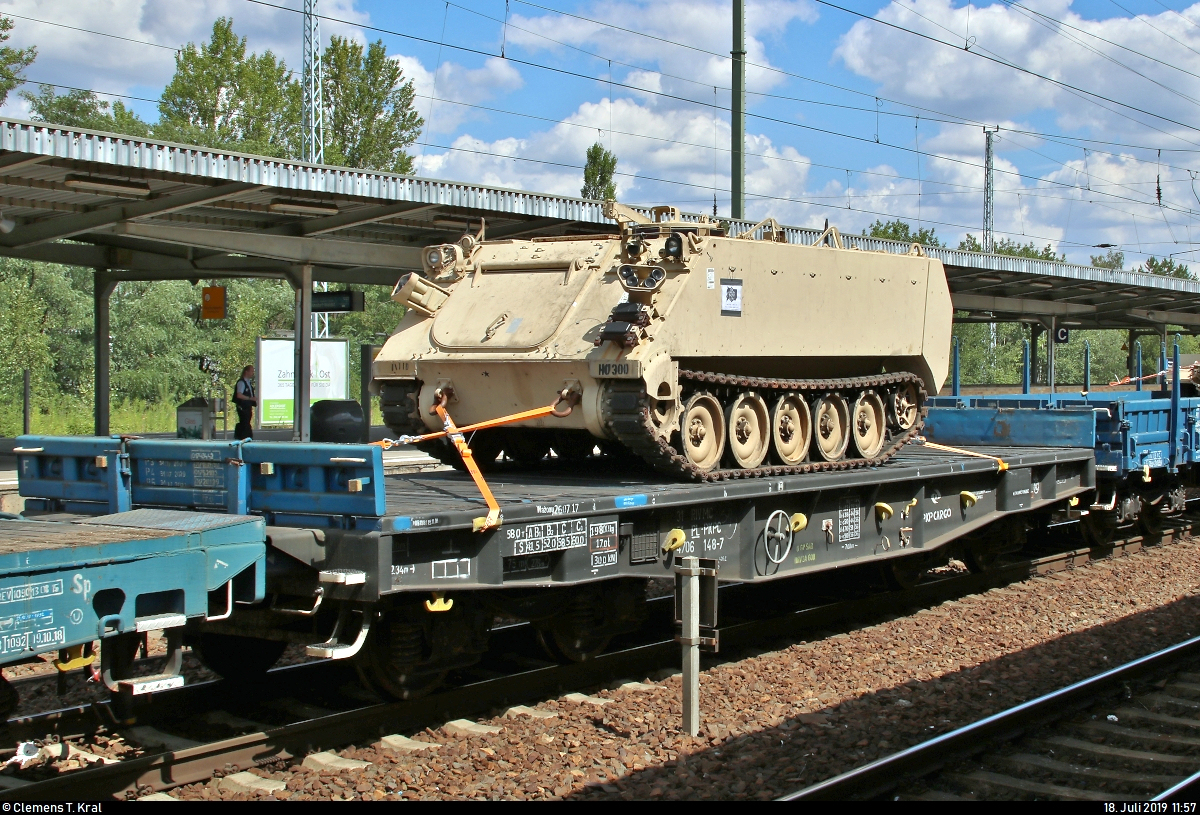 Blick auf einen polnischen vierachsigen Flachwagen der Gattung  Slmmps 443Z  (31 51 4706 148-7 PL-PKPC) von PKP Cargo S.A., beladen mit einem panzerähnlichen Fahrzeug der United States Army, der in einem Militärzug, kommend vom Grünauer Kreuz, mit Zuglok 145 045-1 DB eingereiht ist und während eines längeren Aufenthalts im Bahnhof Berlin-Schönefeld Flughafen auf dem Berliner Außenring (BAR | 6126) steht.
Wer mehr über das Fahrzeug weiß, kann sich gerne melden. Dann kann ich die entsprechende Bezeichnung ergänzen.
[18.7.2019 | 11:57 Uhr]