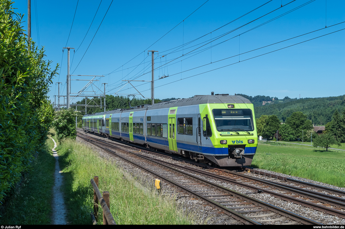 BLS RABe 525 029 und eine weitere NINA fahren am 11. Juni 2017 bei Riedbach als S5 in Richtung Bern. Auf der im Hintergrund sichtbaren Wiese soll in wenigen Jahren eine neue Werkstätte der BLS entstehen.