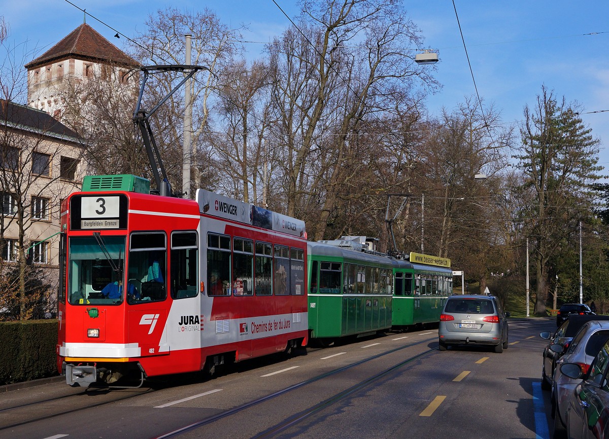 BVB/CJ: In der Stadt Basel ist der BVB Be 4/4 482 (1986) seit einiger Zeit mit einer Vollwerbung für die Chemins de fer du Jura unterwegs. Am 11. März 2014 konnte er auf der Hardstrasse vor einem Dreiwagenzug der Linie 3 (mit verschiedenen Be 4/4-Triebwagen an beiden Enden) im Bilde festgehalten werden. Er war im letzten Abendlicht unterwegs in Richtung Burgfelden Grenze.
Foto: Walter Ruetsch  