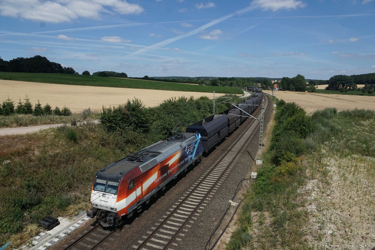 Captrain 185 CL 002 mit Salzgitter-Mannesmann-Werbung und Kohlenzug am 07.07.2019 auf dem Weg ins Ruhrgebiet. 