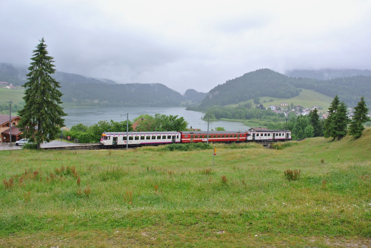 Da der  neue  Schlerzug aus dem Valle de Joux zurzeit bei den TPF in Bulle im Unterhalt ist verkehrt im Moment wieder der alte, ehem. MThB Pendel mit dem ex. RVT Zwischenwagen, les Charbonnires, 02.07.2014.