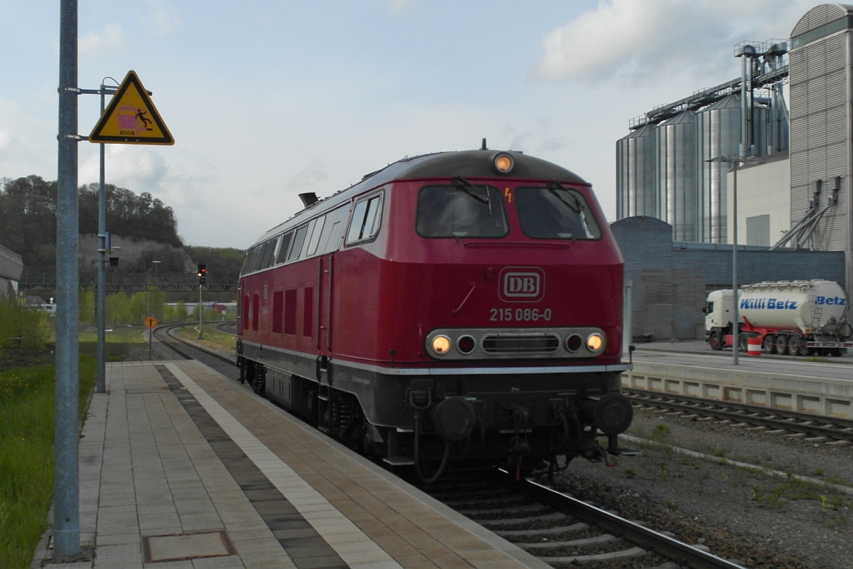 Da steht der wartende Pendler am Bahnsteig und statt eines um diese Zeit planmäßig einfahrenden IRE durchfährt überraschend 215 086-0 in zügigem Tempo den Bahnhof von Biberach (Riß). Am 25.04.2016 wurde eiligst die Kamera aus der Tasche geholt und die Richtung Süden fahrende Lok fotografiert.