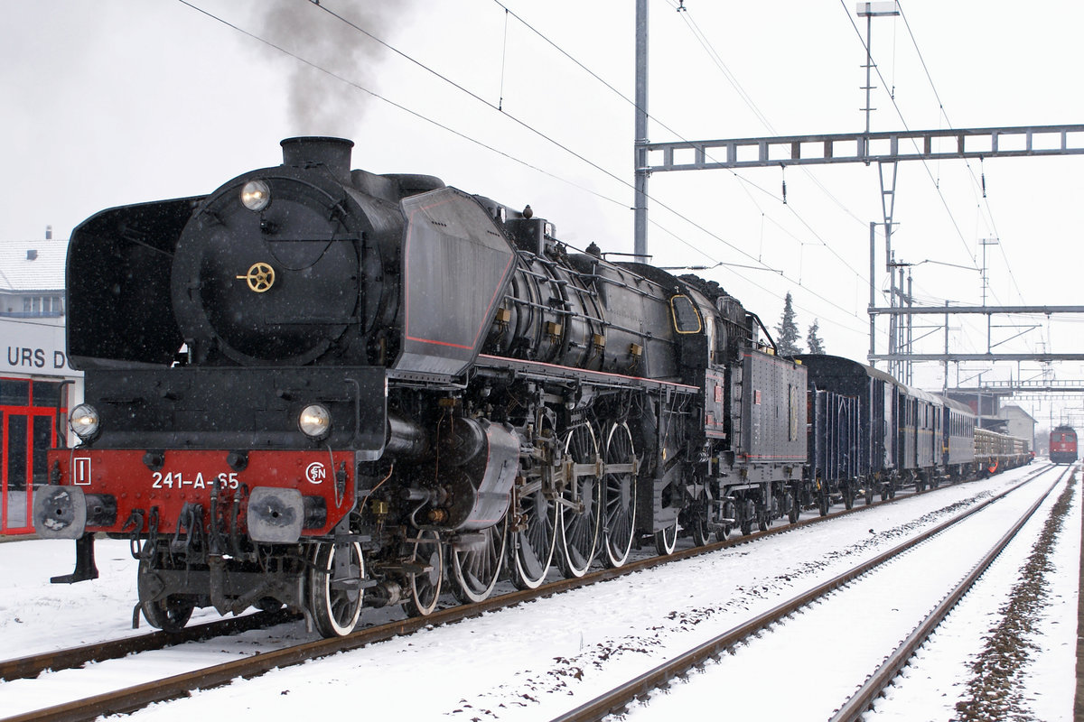 Dampfgüterzüge in der Schweiz auf schmaler und normaler Spur
stellen eher eine Seltenheit dar.
In den Jahren 1986 und 2009 ist es mir gelungen solche Züge zu fotografieren.
Zur Zeit befinden sich beide Raritäten gemäss ID 1136943, 1136942, 1136941 und 1136940, 1136939, 1136938 in einem nicht betriebstüchtigen Zustand.
Dampfgüterzug mit der 241-A-65, ehemals französische Ostbahn (Chemin de Fer de l'Est) in Oberbuchsiten am 13. Februar 2009.
Zum Fotostandort: Bildausschnitt Fotoshop.
Foto: Walter Ruetsch