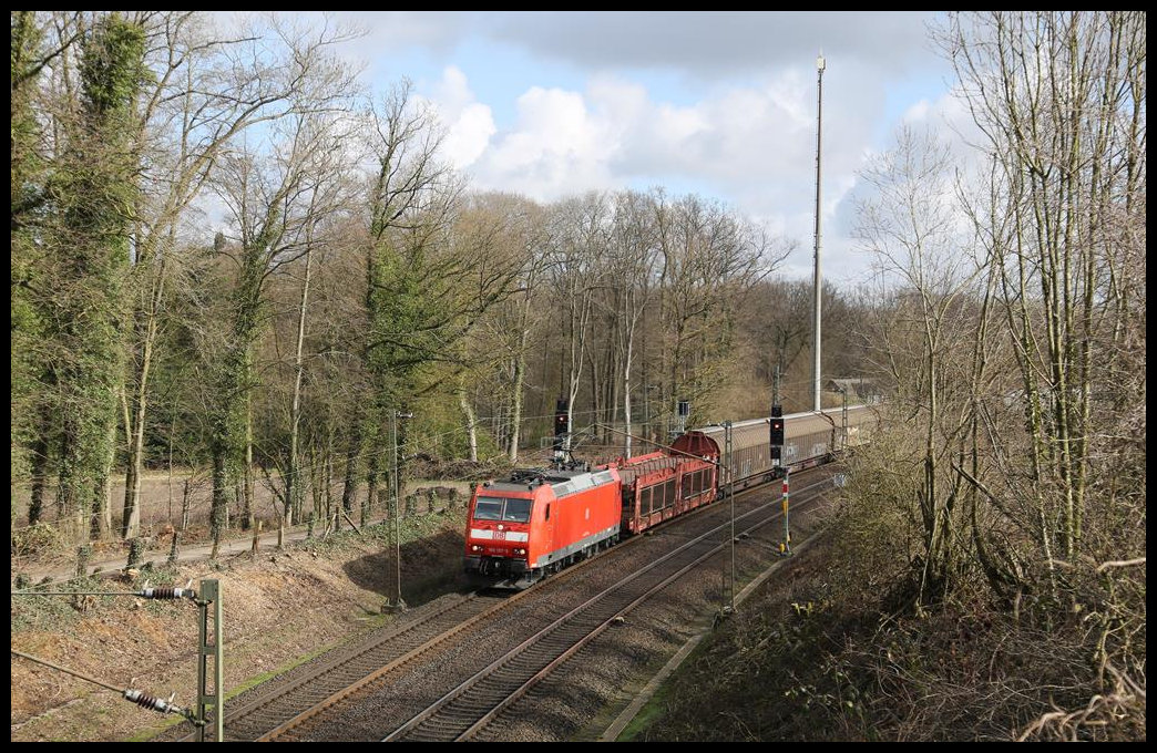 DB 185157-5 ist hier am 19.3.2019 um 10.17 Uhr auf der Rollbahn am Ortsrand von Hasbergen mit einem Güterzug in Richtung Münster unterwegs.