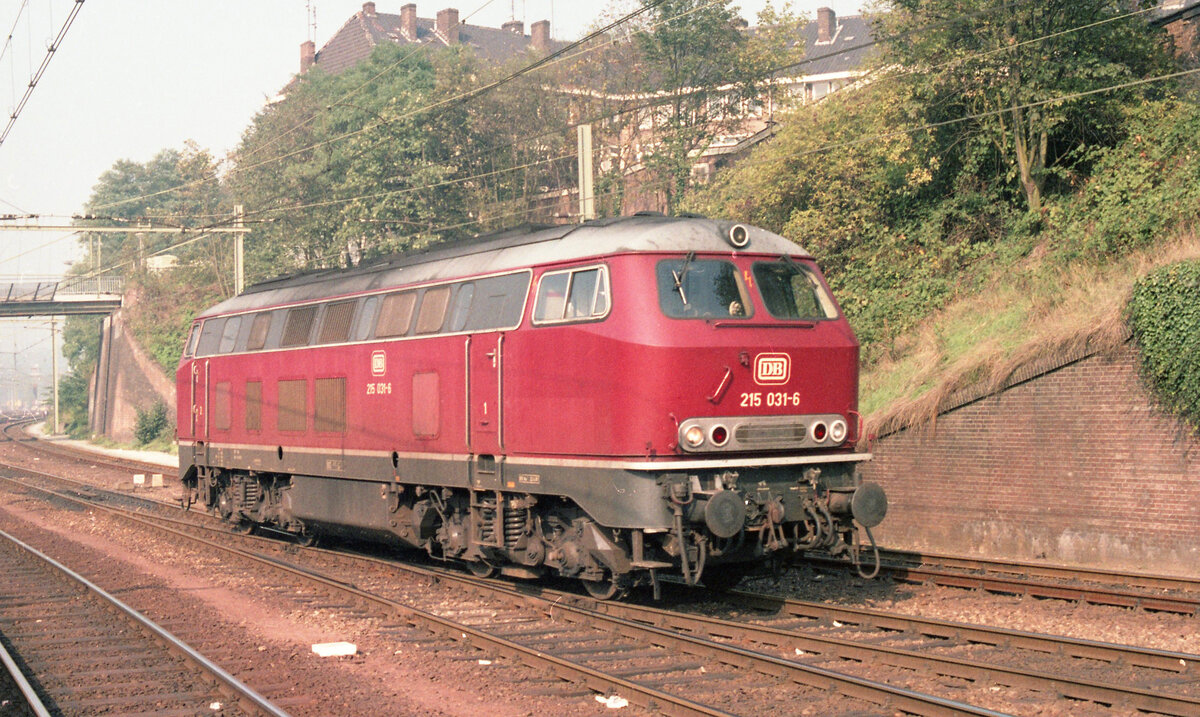 DB 215.031-6 kommt aus der Abstellung in den Bahnhof Arnhem am 29.09.1983 und fährt zum Bahnsteig. Die Lok soll hier D-417 (Amsterdam CS - München Hbf) übernehmen zur Weiterfahrt über Nijmegen, Kleve und Krefeld. Scan (Bild 93239, Kodacolor400).