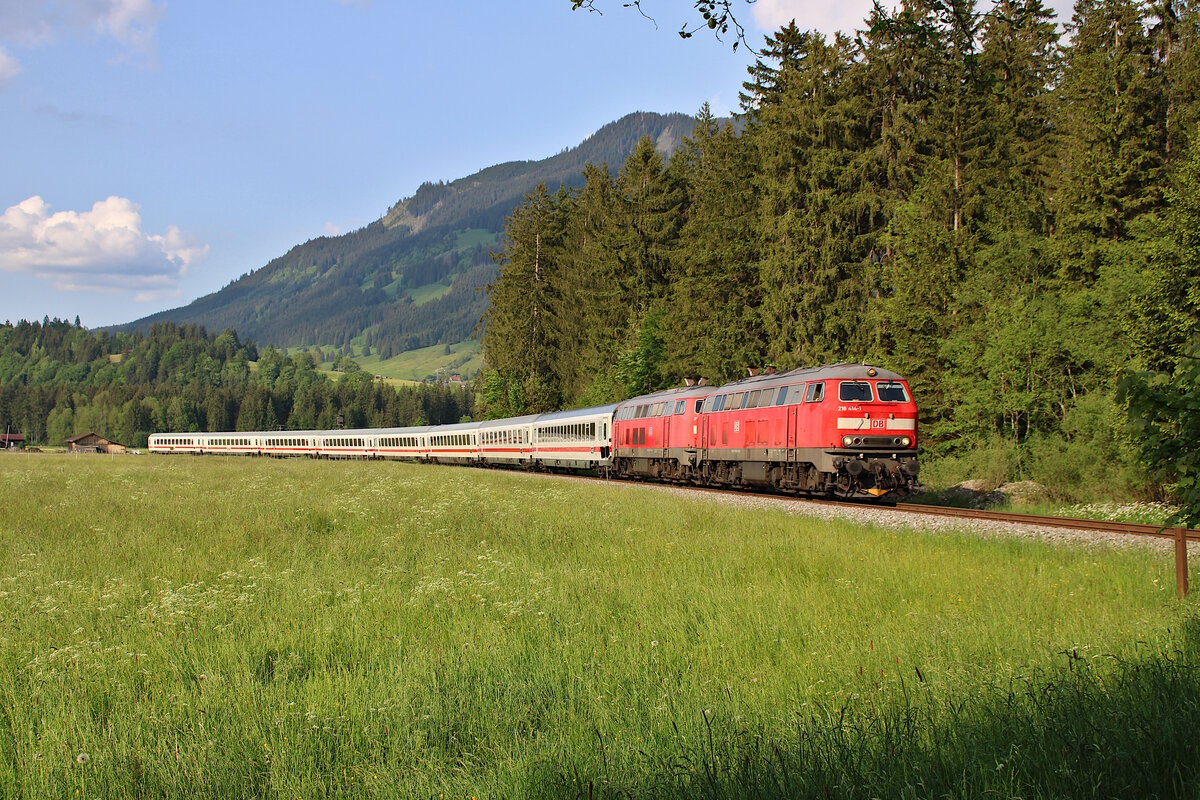 DB 218 414-1 rollt mit 218 424-0 und dem IC 2013 gemütlich aus dem Bahnhof Langenwang in Richtung Oberstdorf. (28.05.2023)
