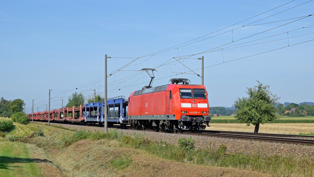 DB Cargo 145 039 mit leerem Autotransportzug in Richtung Hannover (bei Bruchmühlen, 23.08.19).