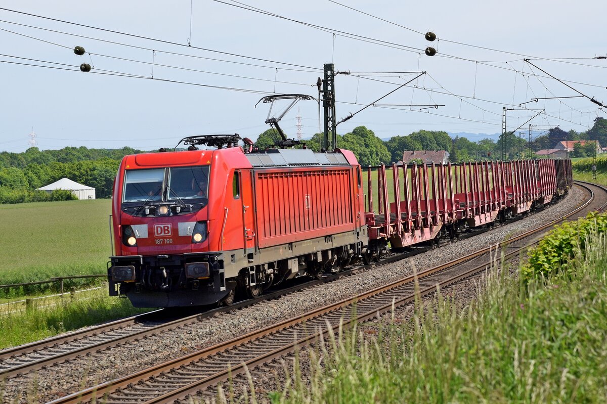 DB Cargo 187 160 mit Rungenwagen in Richtung Osnabrück (Bohmte-Stirpe, 31.05.2023).