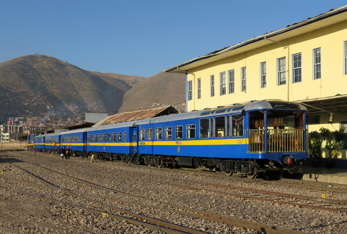 Der 'Anden Explorer' mit dem Aussichtswagen mit der offenen Plattform am Schluss nach Puno wartet in Cusco in der Morgensonne auf die Abfahrt, gesehen von einem Bahn�bergang aus. Cusco, 18.7.2015