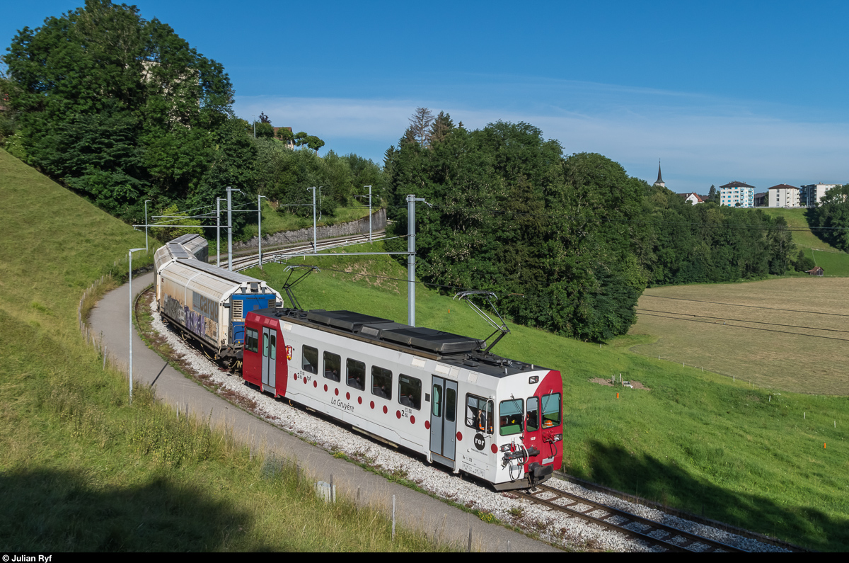 Der Be 4/4 123 befindet sich am 7. Juli 2016 mit seinem morgendlichen Rollschemelzug zur Cailler Schokoladenfabrik kurz vor seinem Ziel Broc Fabrique.