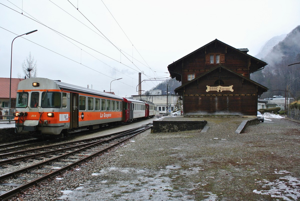 Der Bt 254, noch in der alten GFM Farbgebung, mit dem Bt 251 und dem BDe 4/4 141 an der Endhaltestelle Broc Fabrique, 14.01.2014.