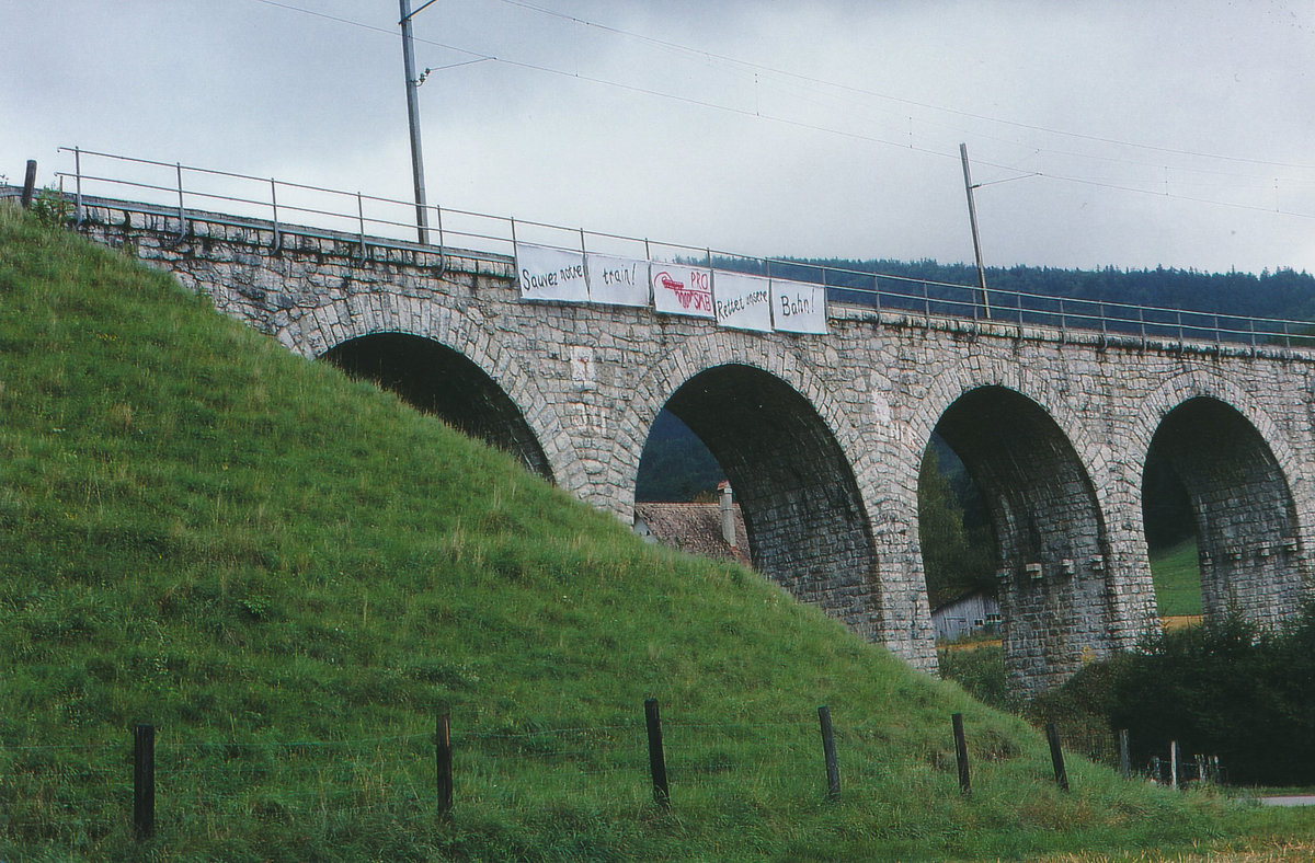 Der Kampf gegen die Stilllegung der Bahnstrecke Solothurn-Moutier.
SMB: Bereits im Jahre 1996 drohte die Betriebseinstellung der SMB. Für den Erhalt der Bahn wurde ein Verein Pro SMB gegründet. Am 16. September 1996 kam es in Solothurn zu einer grossen Kundgebung. Als Demonstrationszug von Solothurn nach Moutier und zurück stand ein fünfteiliger Miragependelzug mit dem BDe 4/4 II 252  Willisau  im Einsatz. Auf der Rückfahrt wurden am Viadukt in Corelles entsprechende Transparente ausgerollt. 
Foto: Walter Ruetsch 