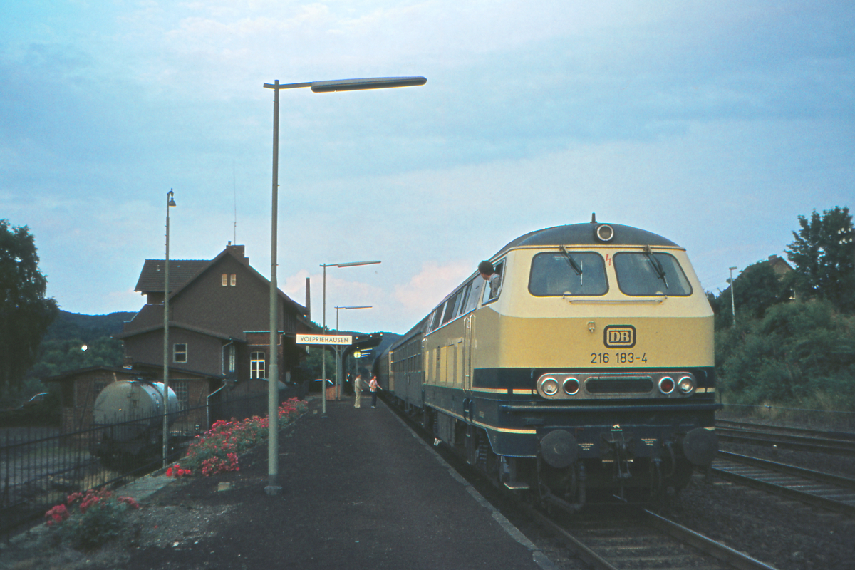 Der Lokführer der 216 183 mit dem Eilzug Walkenried - Oberhausen wartet im Bahnhof Volpriehausen auf den Abfahrauftrag. Der Eilzug durchquerte einmal die damalige Bundesrepublik - von der Grenze zur DDR bis an den Rhein. Wie oft müßte man wohl heute, im Jahr 2022 umsteigen, wollte man diese Reise machen? Volpriehausen, 15. August 1979