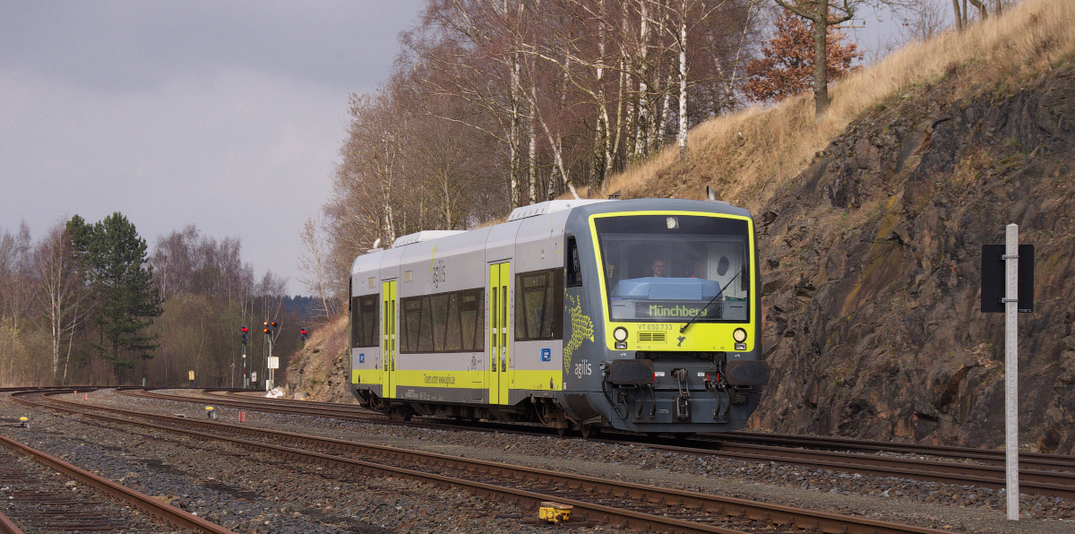 Der Lummerland Express - Weil die Triebwagen von Agilis oft mit der Zielanzeige Lummerland versehen sind, wenn sie in Hof abgestellt sind, habe ich den Begriff  Lummerland Express  für die Regio Shuttle von Agilis  erfunden !
VT 650.733 ist auf der Relation von Bad Steben über Hof nach Münchberg unterwegs.
Etwas weniger als 1 Kilometer sind es noch bis zum Bahnhof Oberkotzau.
Dort teilt sich die Strecke nach Selb, nach Weiden und nach Bamberg.
Der Triebwagen befindet sich hier in Höhe des ehemaligen Rangierbahnhof Oberkotzau.
Bahnstrecke 5100 Bamberg - Hof am 17.03.2014.