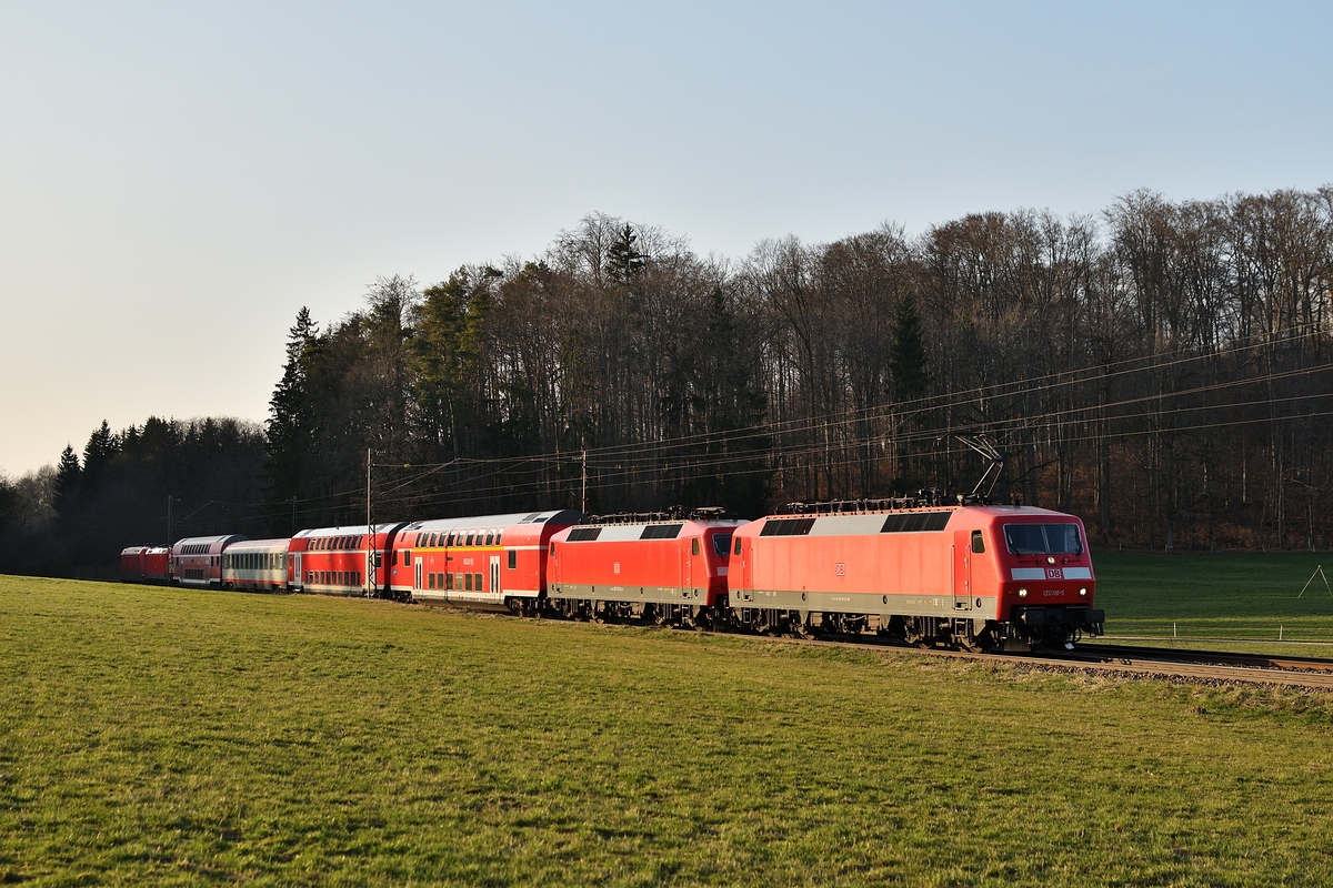 Der PbZ des 19. März 2019 war wohl einen Tag verspätet unterwegs. 120 118 zieht des den bunten Zug am Abend des 20. März 219 durch das Gewann Gurgelhau zwischen Westerstetten und Beimerstetten.