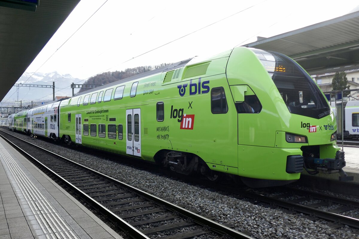 Der RABe 515  Login MUTZ 031  mit der neuen grün weissen Login Vollwerbung am 15.11.25 im Bahnhof Spiez.