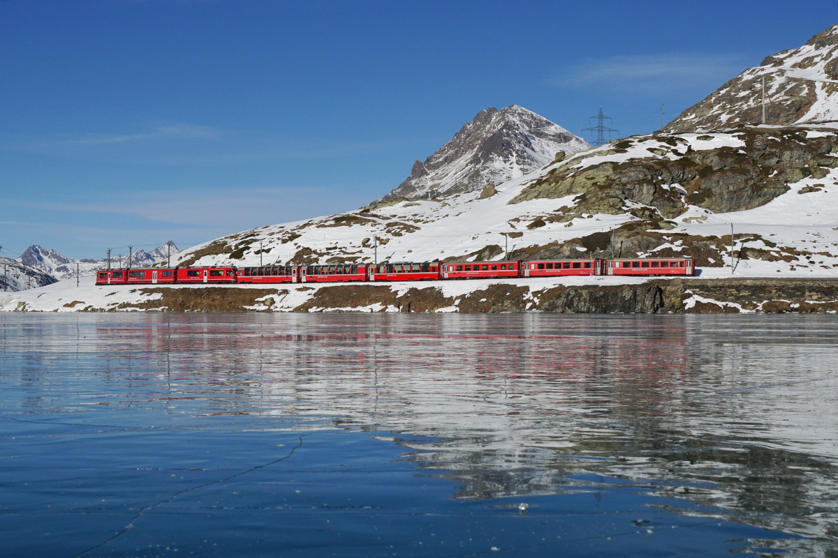 Der Regionalzug 1646 mit dem ABe 8/12 3503 an der Spitze schlängelt sich am 17.12.2016 dem Lago Bianco entlang Richtung Pontresina.