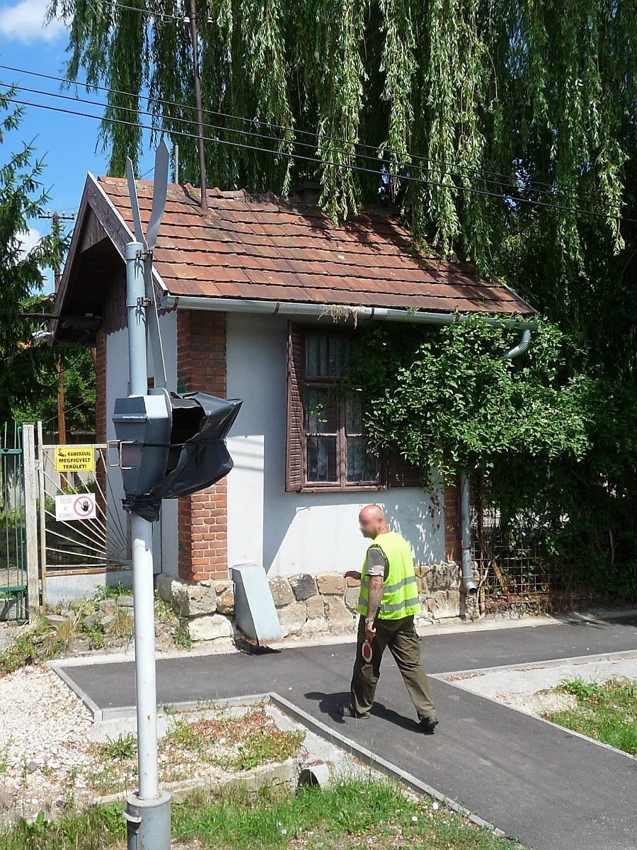 Der  Schrankenwärter  geht wieder in sein Häuschen am Bahnübergang vor Miskolc-Majlath, 10.7.16 

Ein kurzes Video der Straßenquerung gibt es hier:
http://www.bahnvideos.eu/video/Ungarn~Schmalspurbahnen~Miskolc+LAEV/20748/lok-d02-510-der-laev-kreuzt-die.html