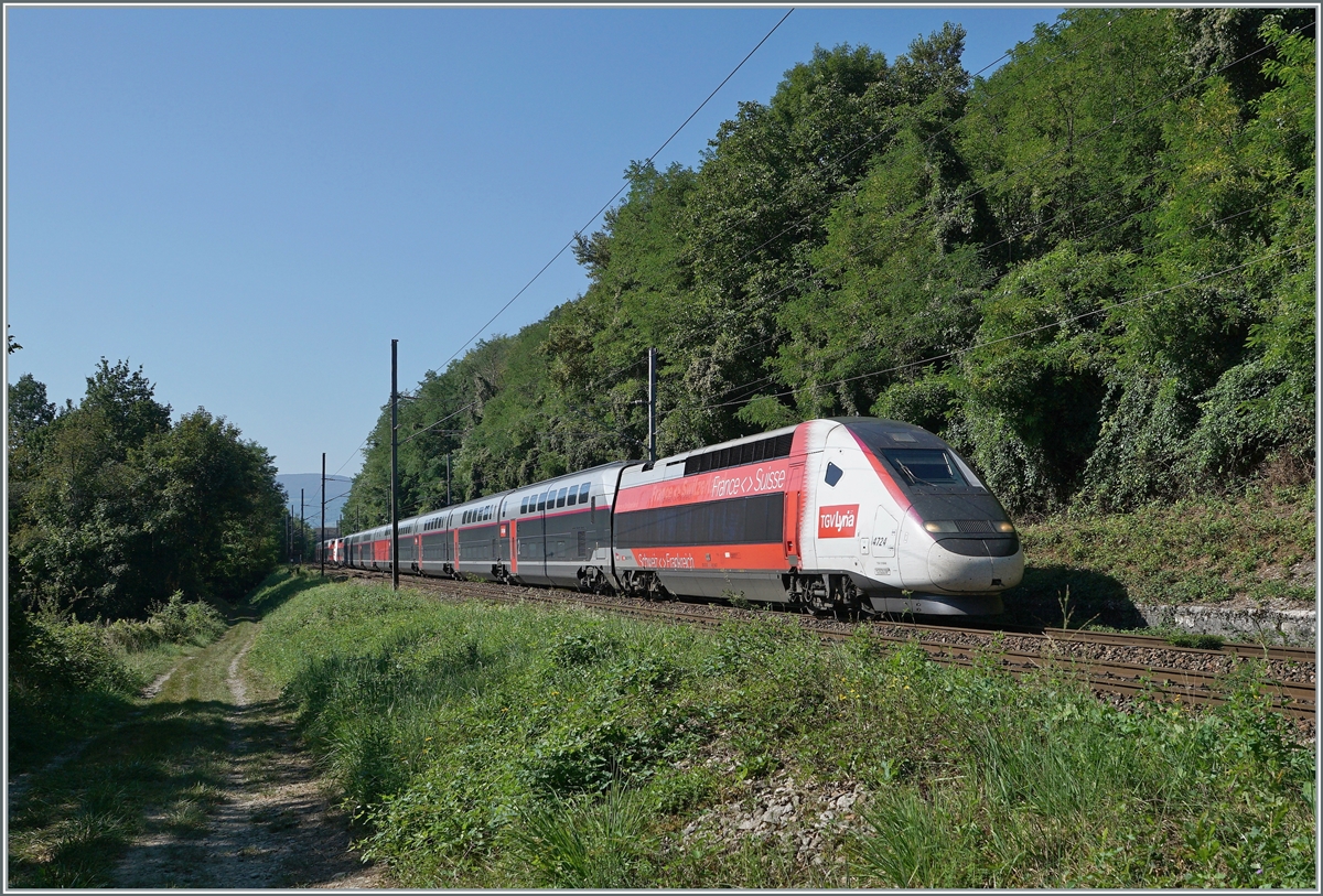 Der TGV Lyria 9763 von Paris Gare de Lyon nach Genève besteht aus den beiden Rame 4724 und 4725 und ist hier etwas auf dem halben Weg zwischen Pougy-Chancy und la Plaine. Links im Bild und angenehm im Schatten, der Wanderweg nach Pougny.

6. September 2021